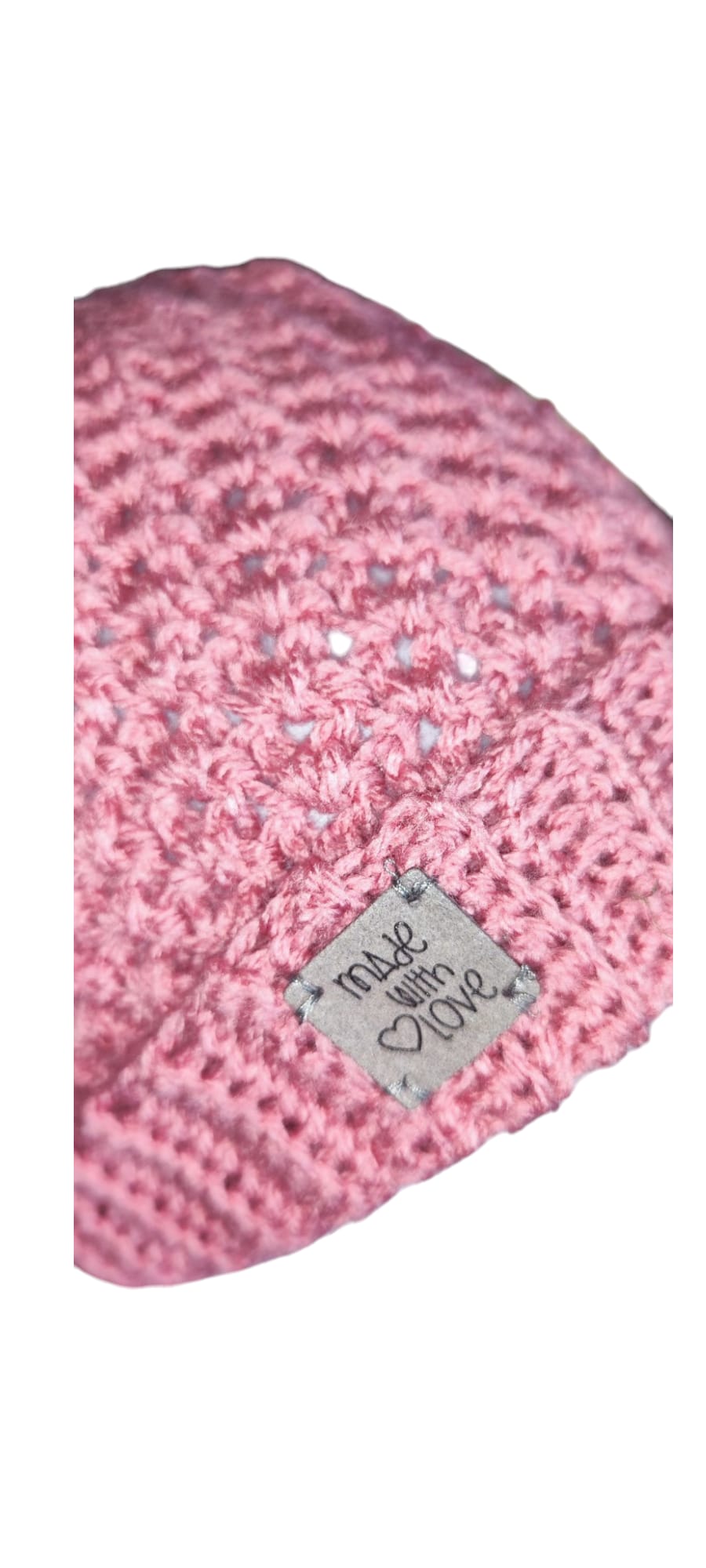 Close-up of the Blush Rose set’s soft pink yarn, fluffy pom-pom, and detailed crochet stitches.