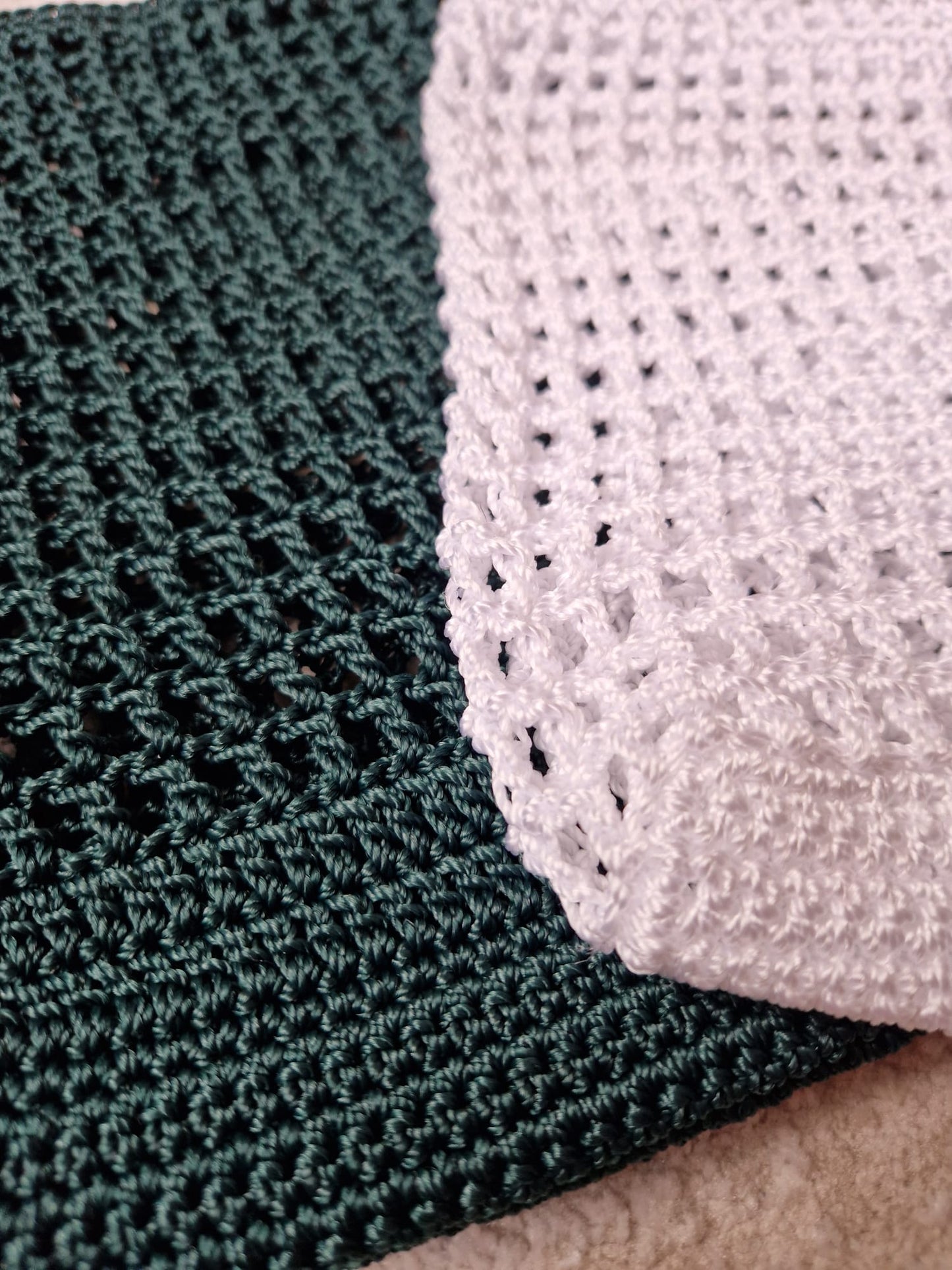 Close-up view of the crochet stitching and strap details on both white and green Breezy Market Totes.