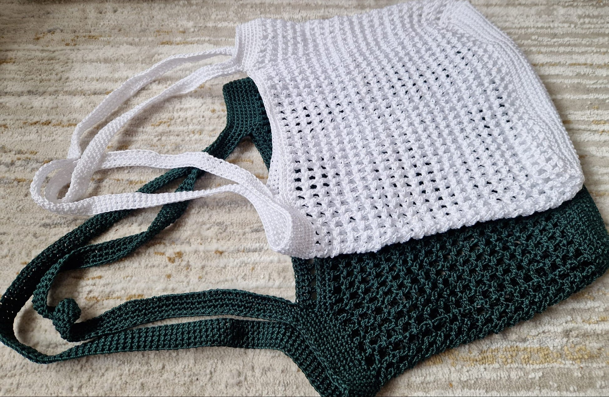 Breezy Market Crochet Tote Bags in white and green displayed side by side, showcasing their shoulder straps and style