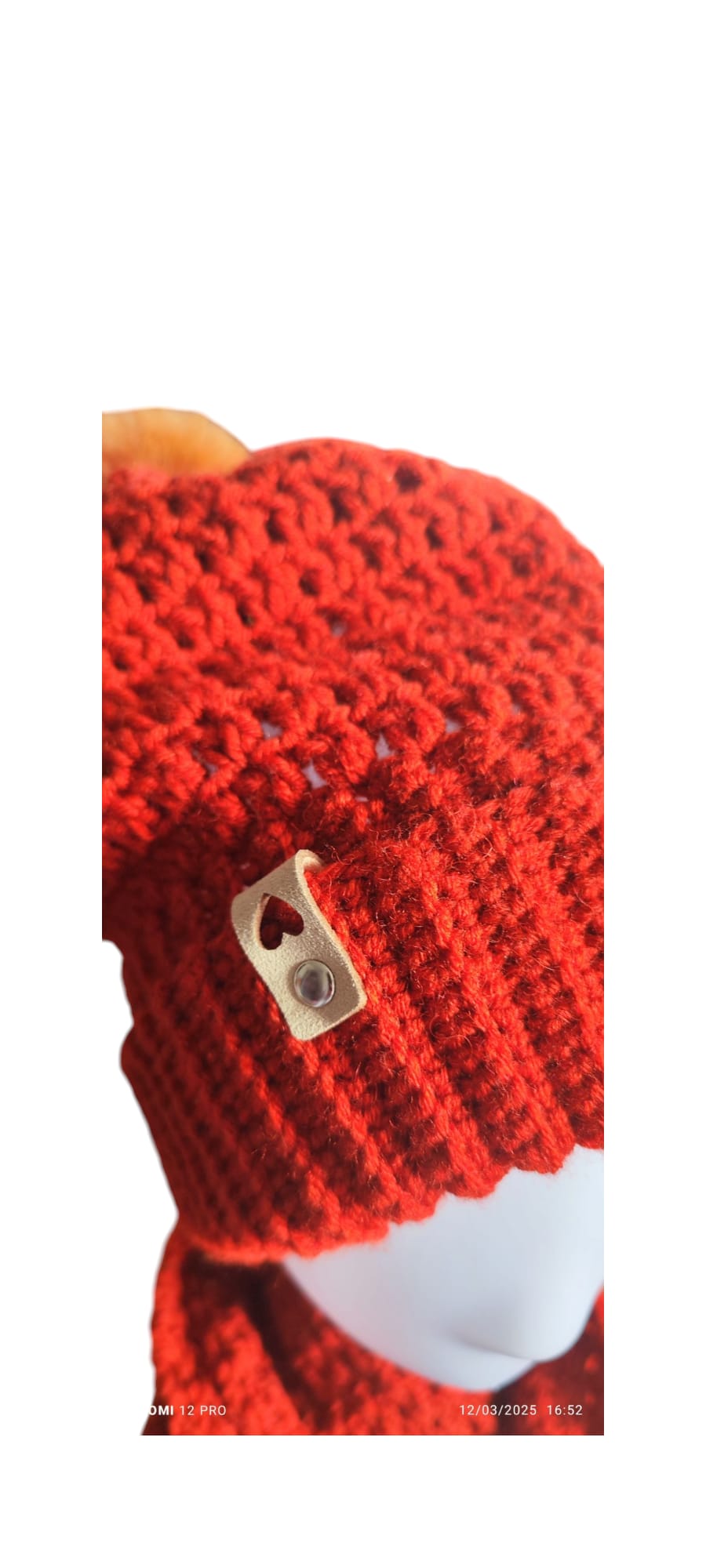Close-up of the Brick Comfort Set’s crochet stitches and the fluffy pom-pom topping the beanie.