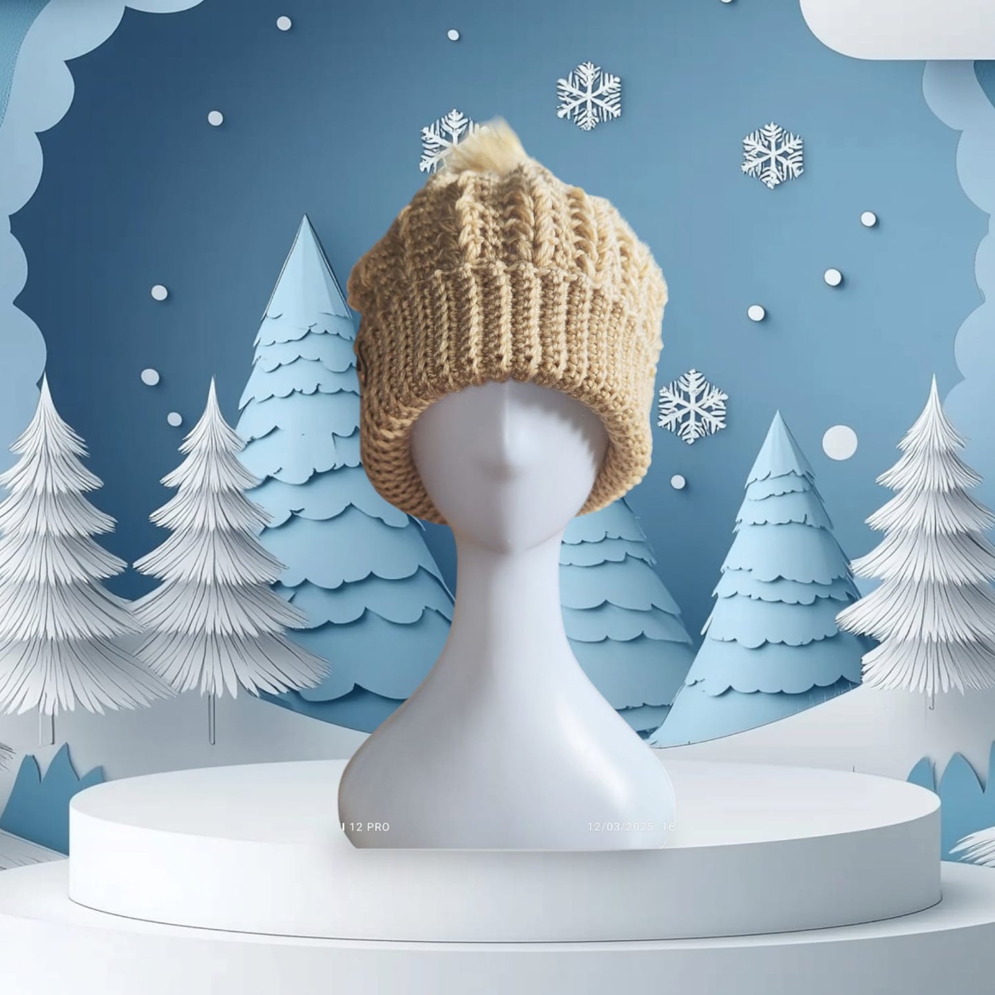 Cozy beige crochet beanie with faux-fur pom-pom styled on a mannequin, set against a snowy winter backdrop.