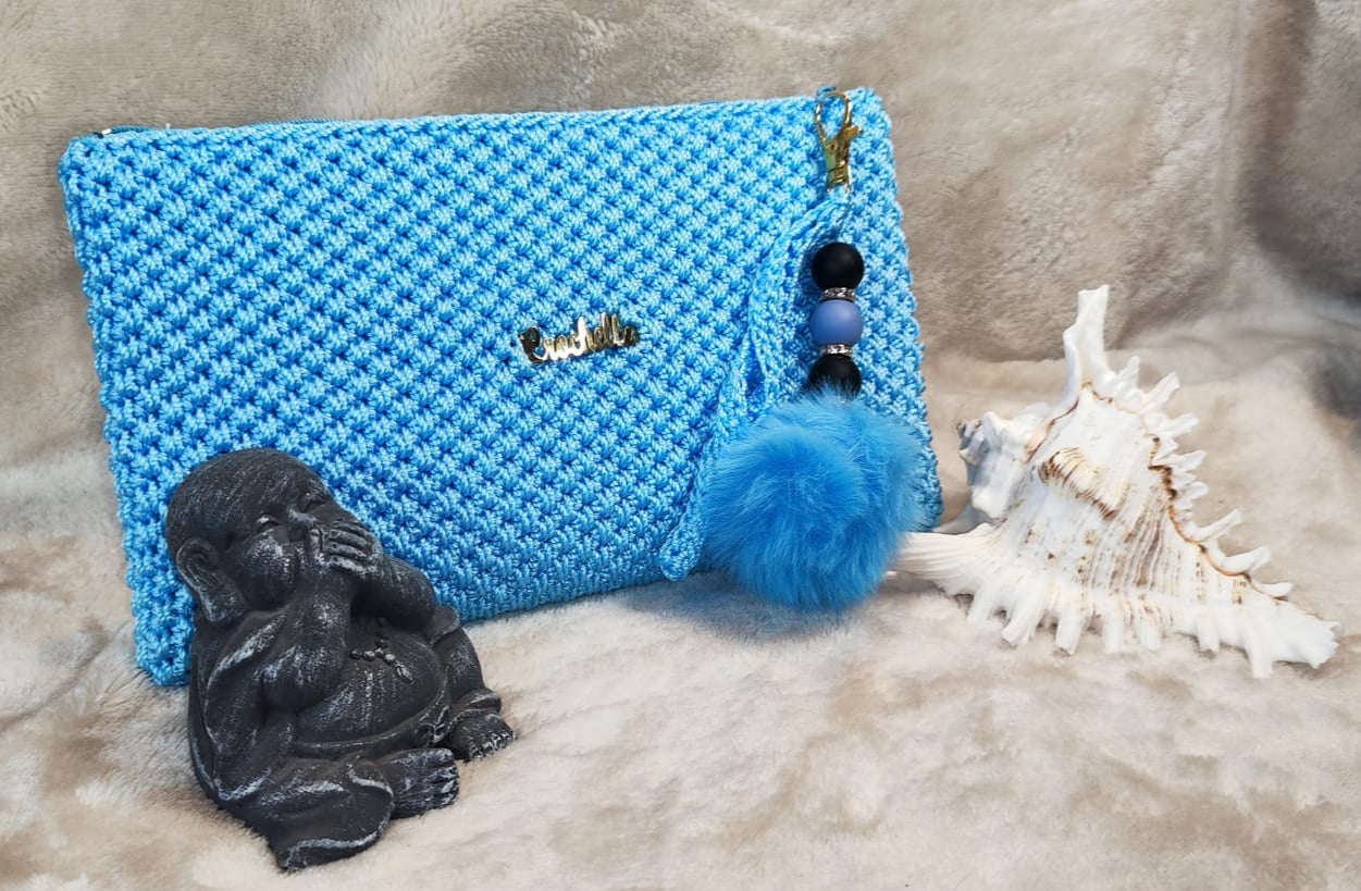 Sky blue Crochella Luxe Clutch with crochet detailing and vibrant charm.