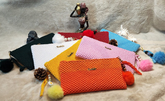 Close-up of Crochella Luxe Clutches in white, yellow, orange, pink, red, blue, and green with colorful keychain charm