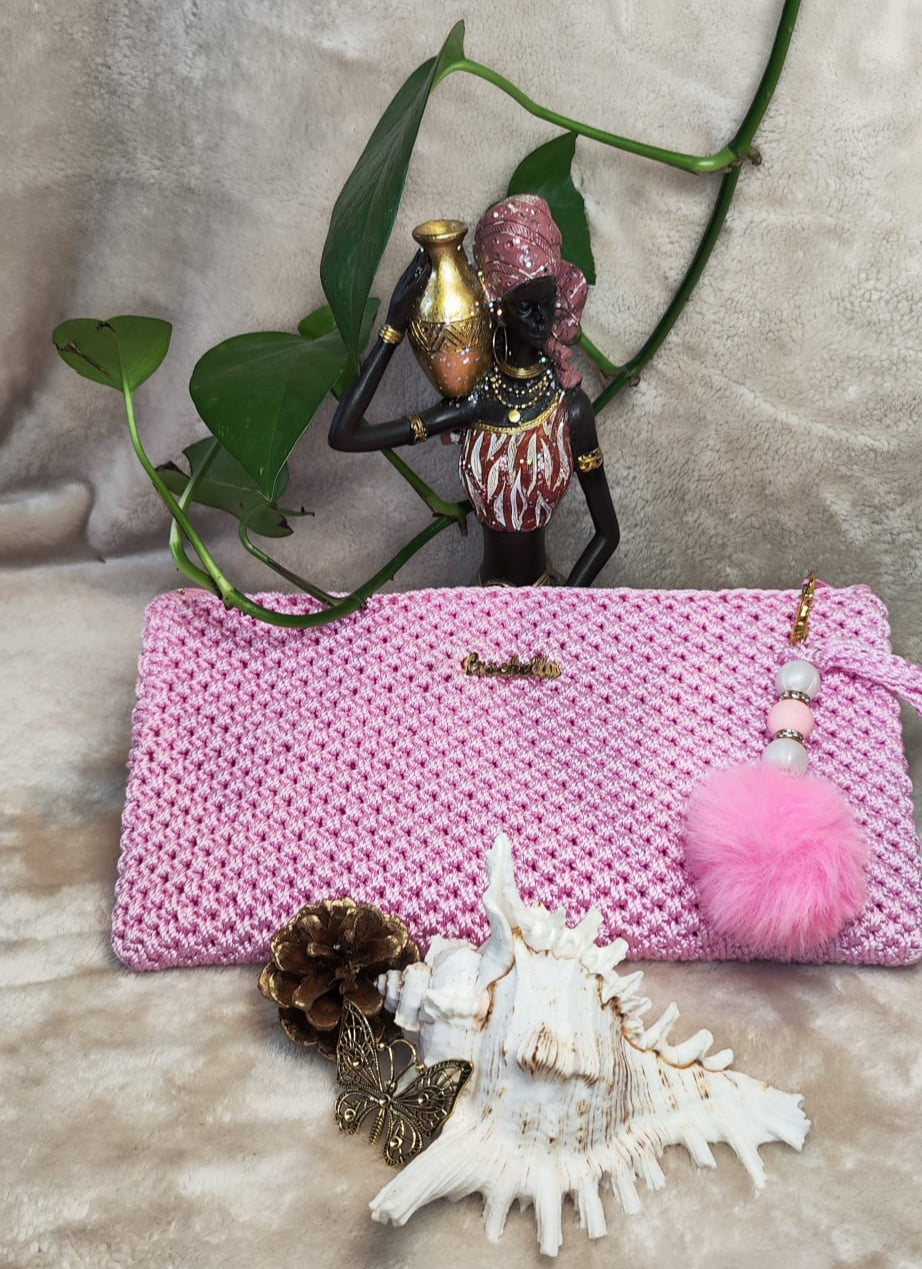 Soft pink Crochella Luxe Clutch with feminine flair and gold lettering.