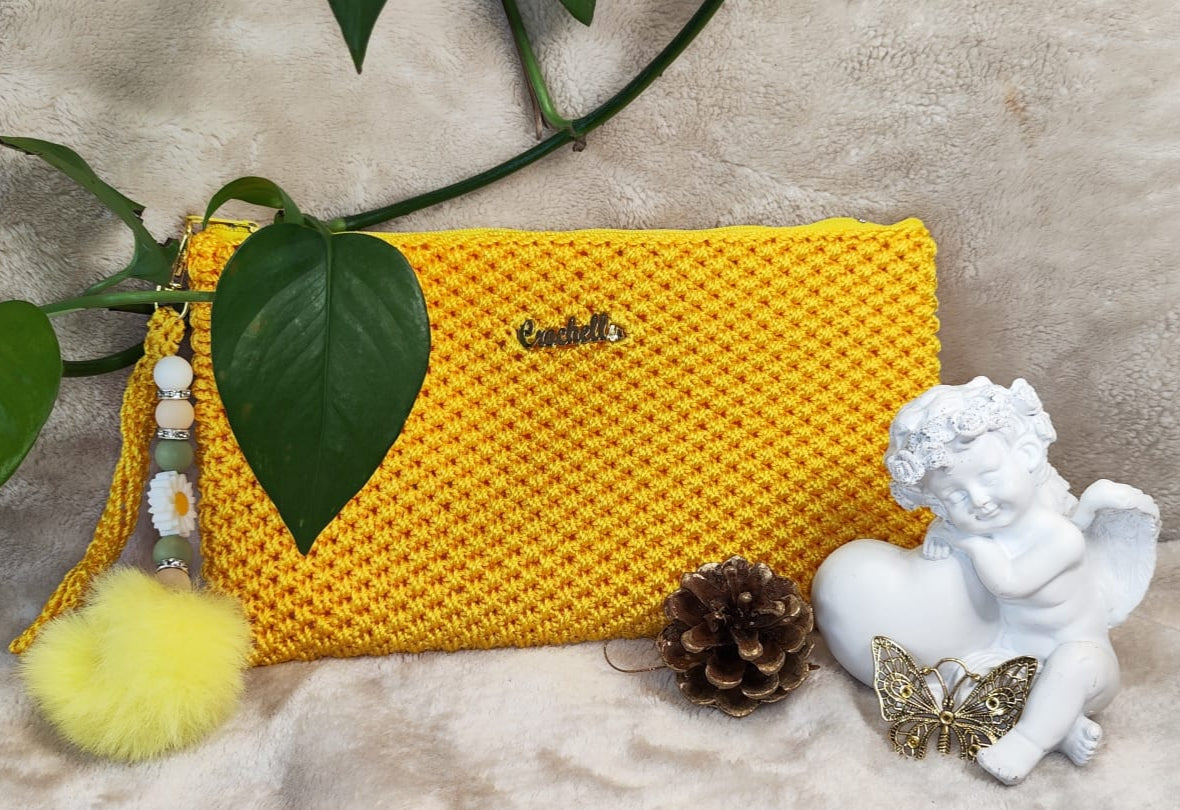 Crochella Luxe Clutch in sunny yellow with playful multicolor charm.