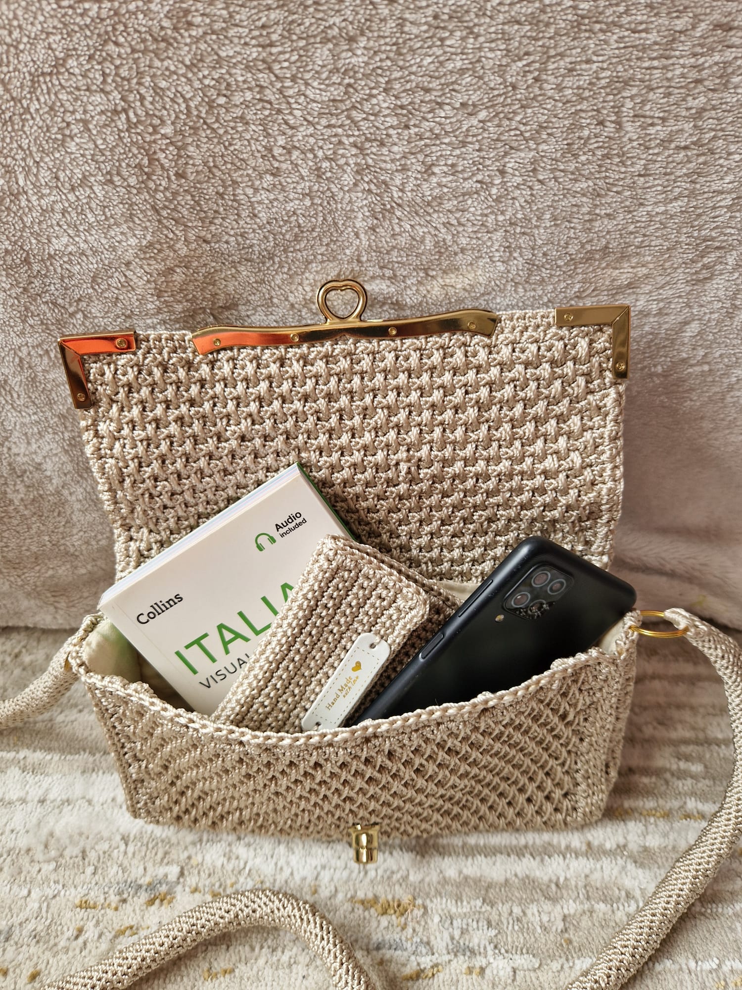 Angled view of the beige Diamond Luxe Bag highlighting its handmade texture and soft shine.