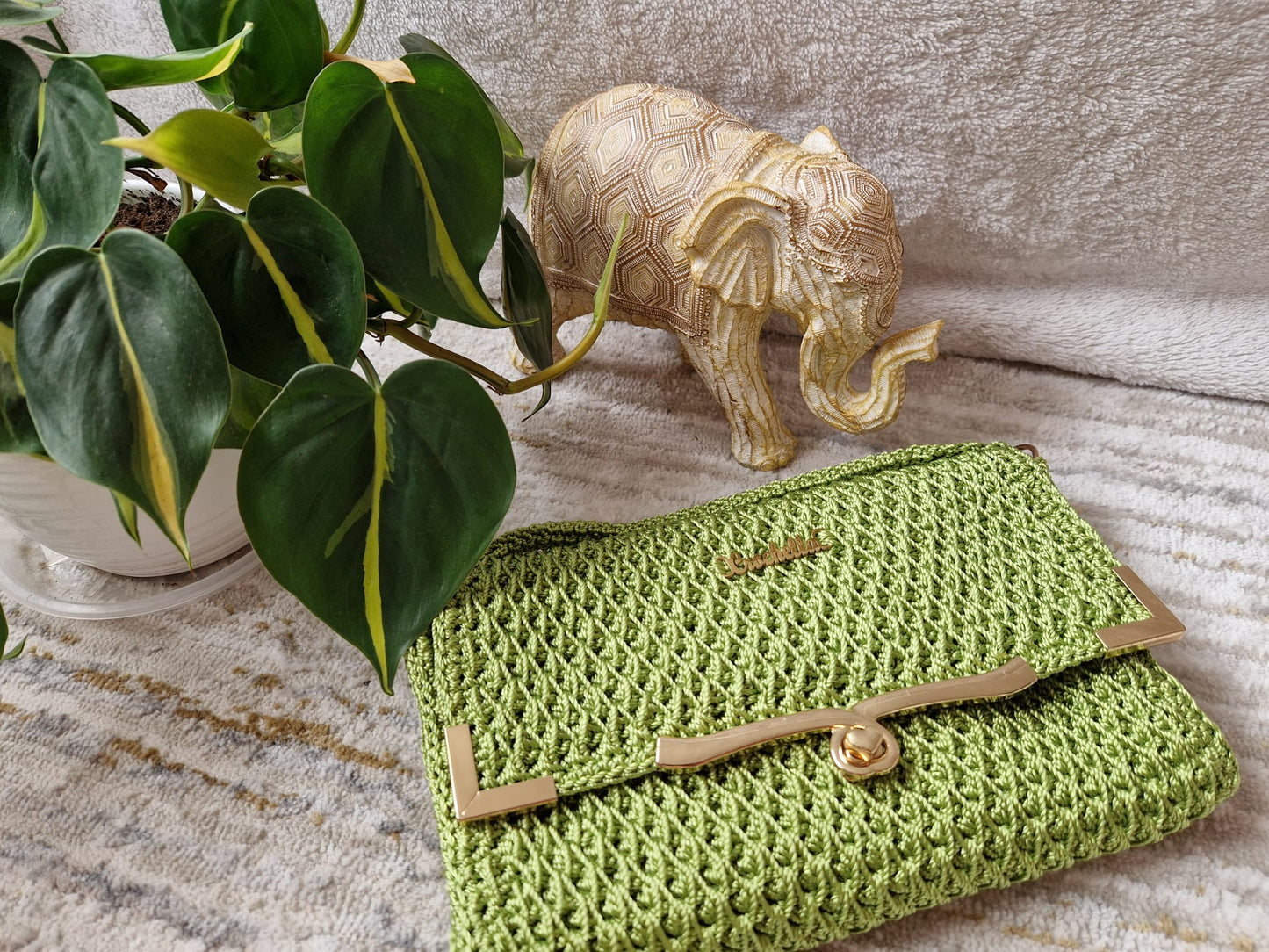 Green Diamond Luxe Crochet Bag with metallic frame and twist clasp, featuring signature diamond stitch design.