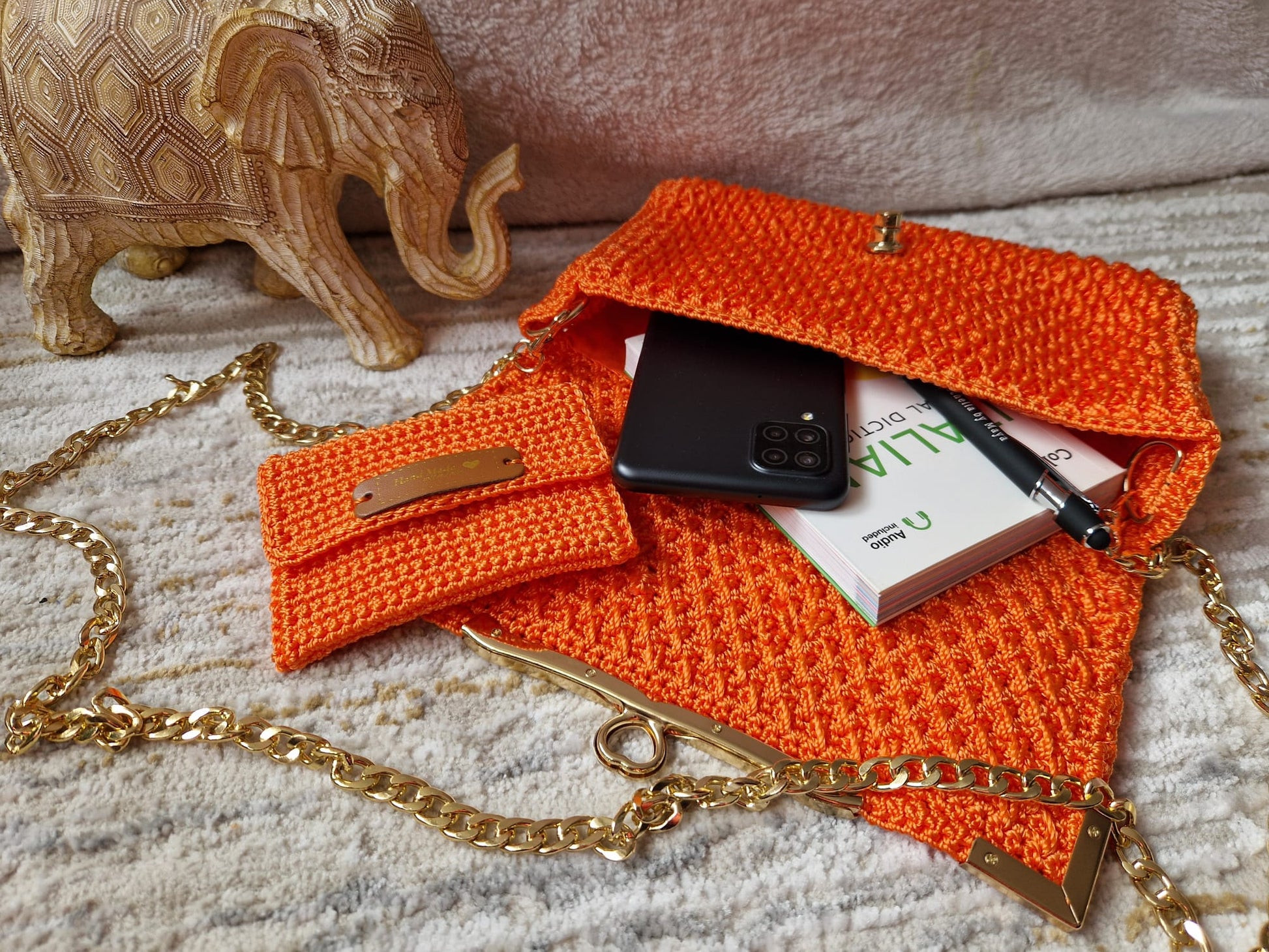 Close-up of the orange Diamond Luxe Bag showcasing detailed crochet stitches and Crochella logo.