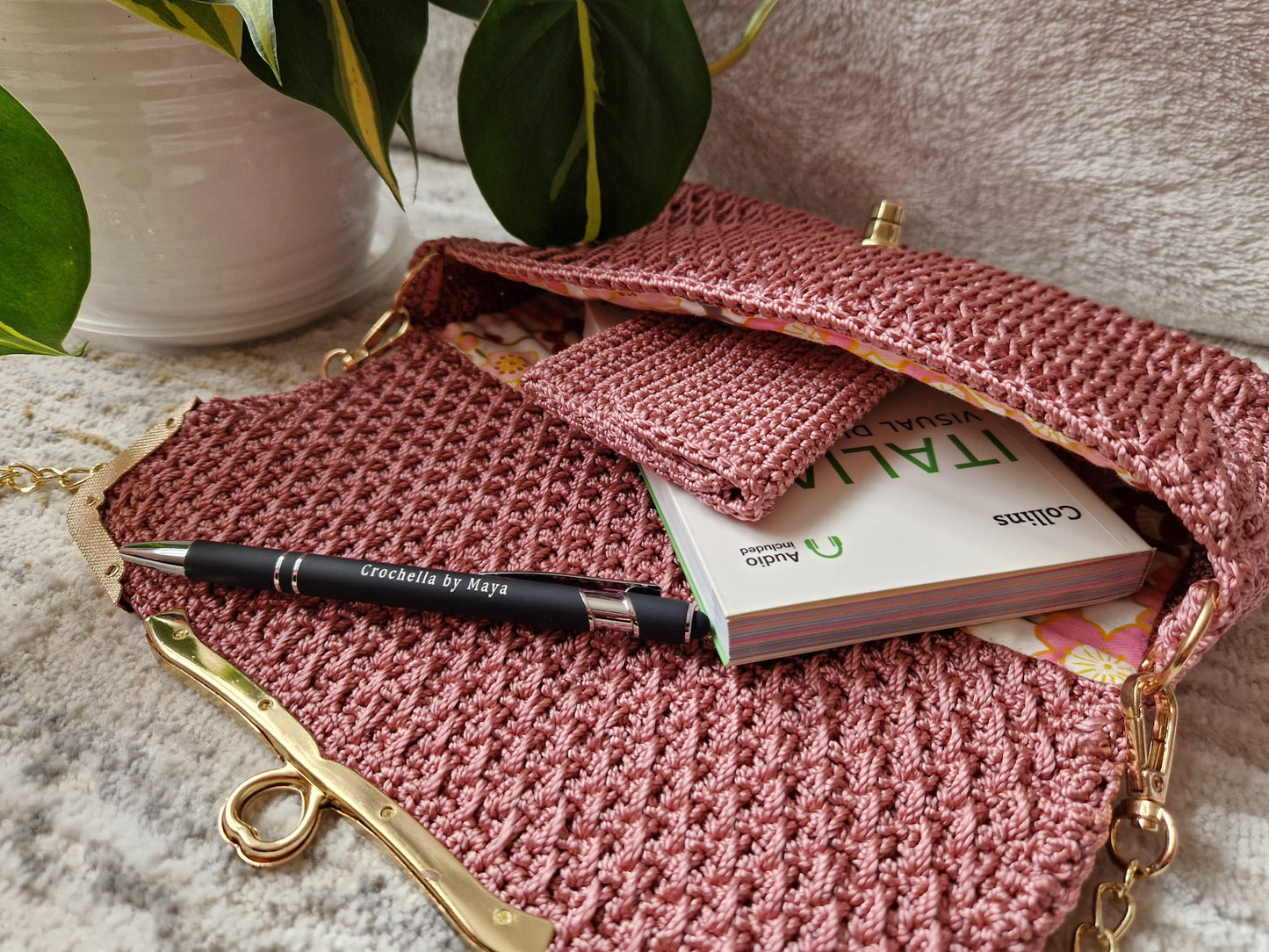 Detail shot of the pink Diamond Luxe Bag featuring fine crochet pattern and signature hardware.