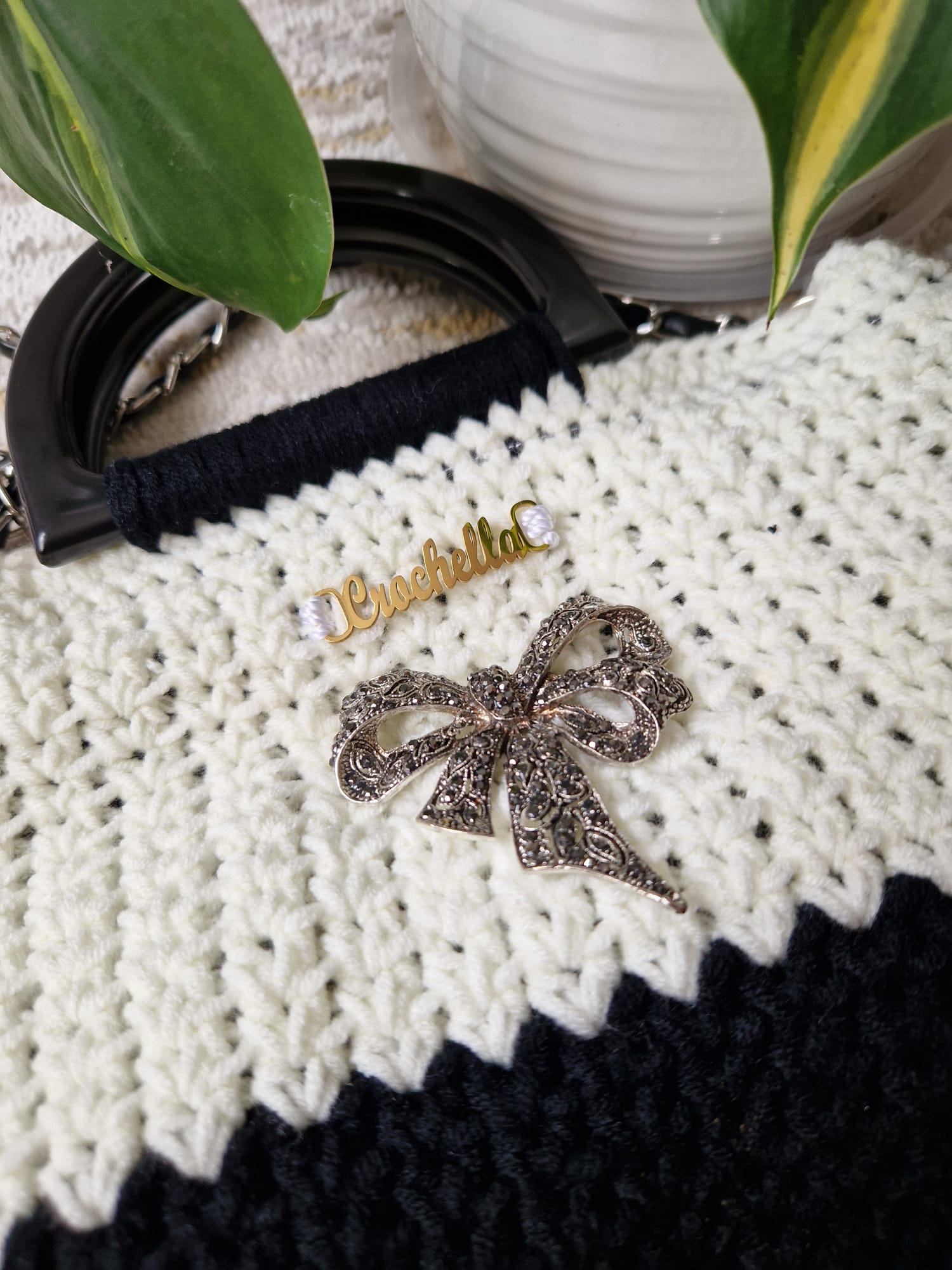 Close-up of the Elegance Bow Crochet Handbag showing the rhinestone bow charm and luxe crochet texture