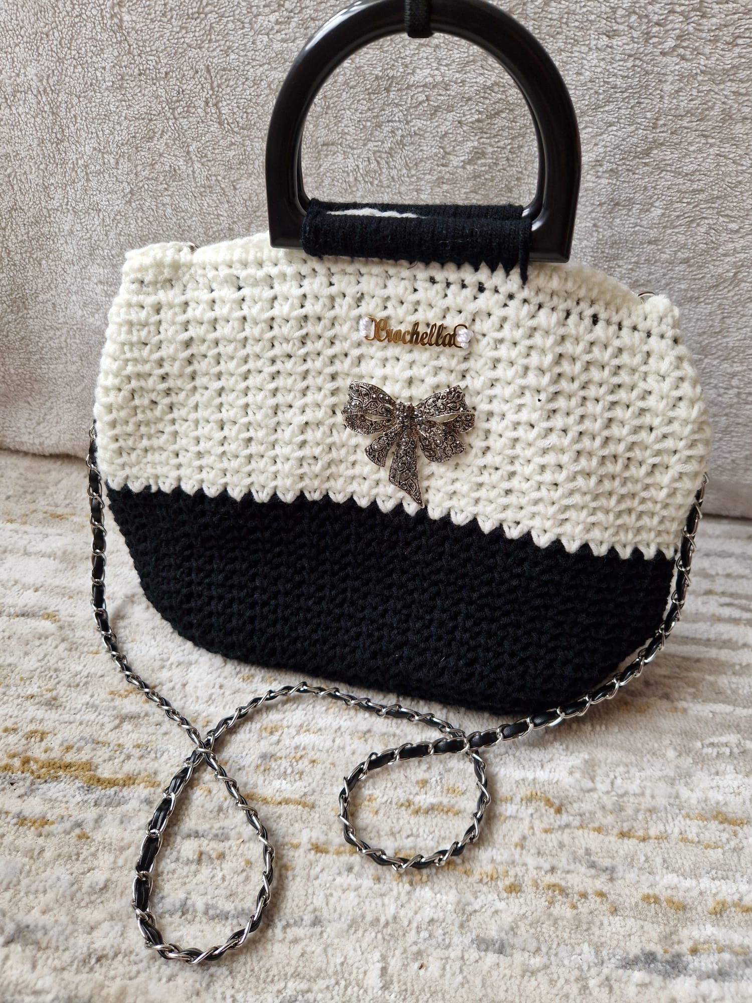 The Elegance Bow Crochet Handbag styled on a soft neutral background, perfect for chic outfits or evening occasions.