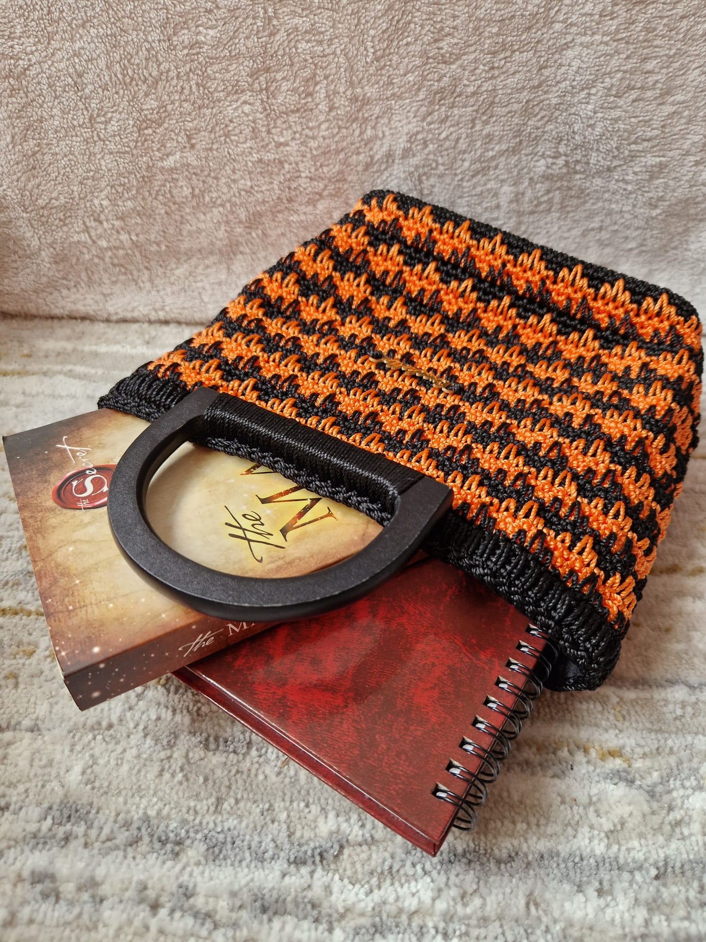 Close-up or angled shot of the Midnight Ember Bag highlighting its vibrant colors and handmade stitch work.