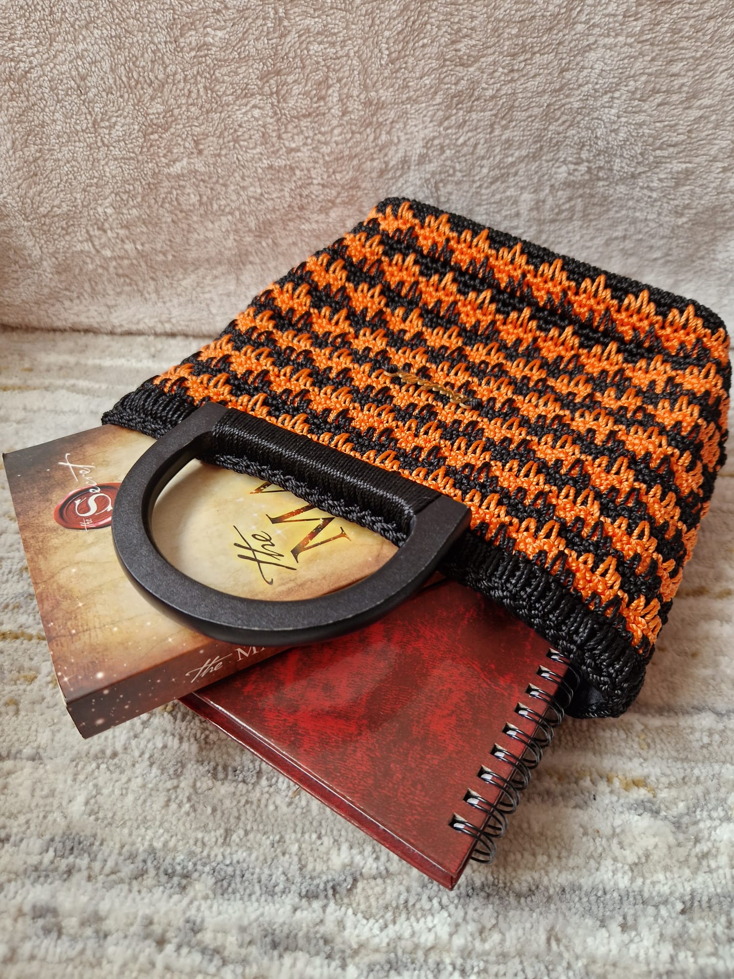 Close-up or angled shot of the Midnight Ember Bag highlighting its vibrant colors and handmade stitch work.