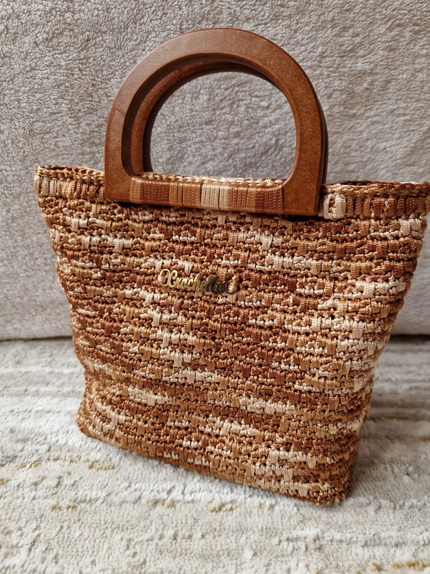 Mocha Mix Ember Stripes Crochet Handbag in warm brown and cream tones with a soft crochet texture and arched handle.