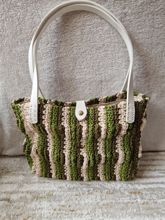 Front view of the Forest Waves handmade crochet bag with white strap accents and textured striped wave design.