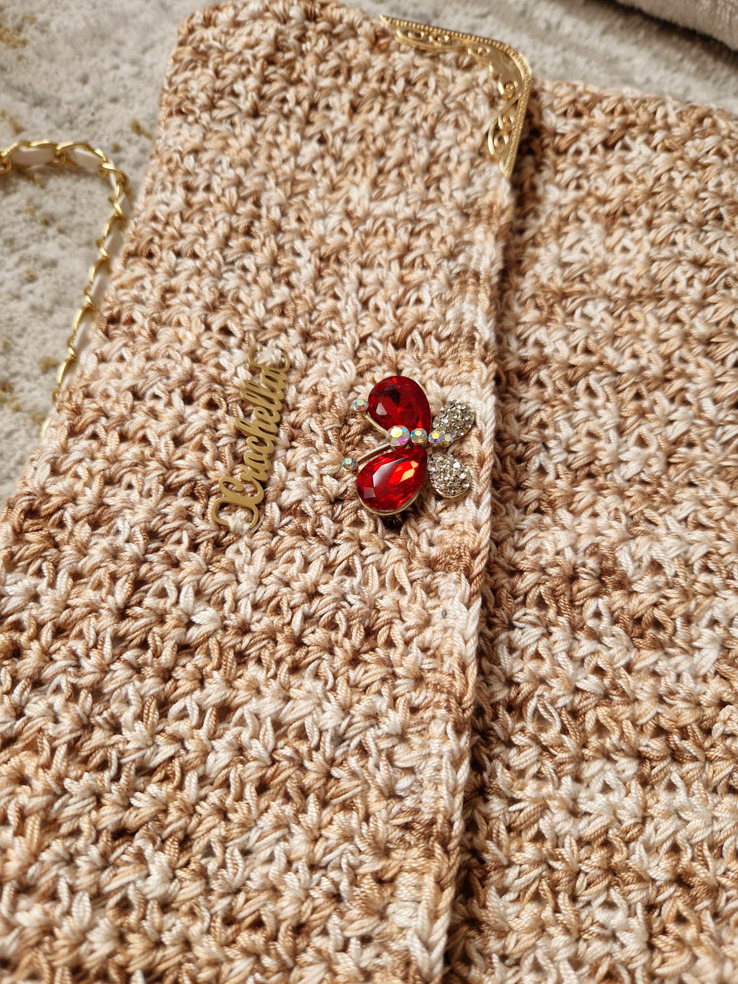 Angled view of the Golden Elegance Crochet Clutch highlighting its fold-over flap and shimmering thread details.