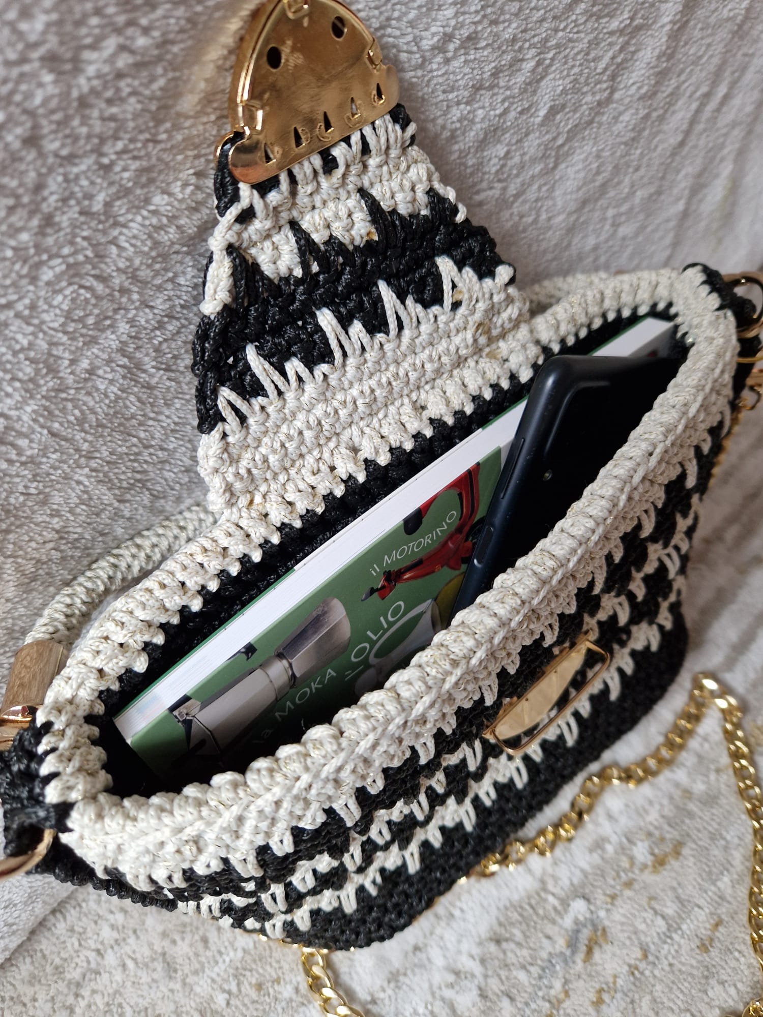 Close-up of the Monochrome Elegance Bag showing the crochet detailing, flap clasp, and metallic accents.