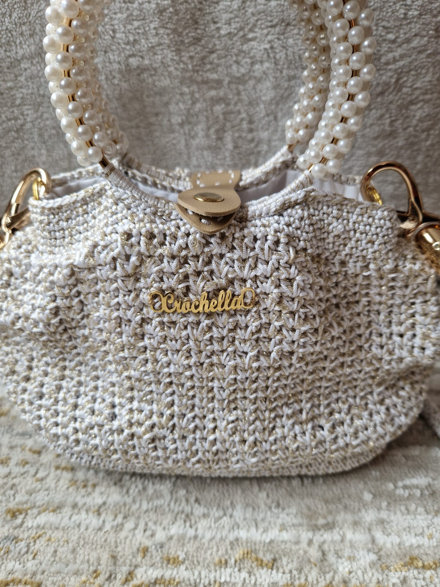 View of the long crochet shoulder strap on the Pearl Luxe Bridal Bag, offering versatility for both hand and shoulder wear.