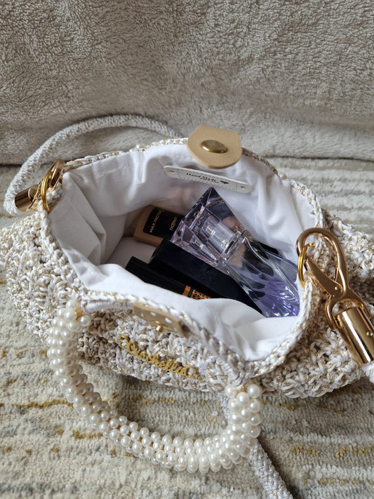 The Pearl Luxe Bridal Bag styled on a neutral background, emphasizing its graceful, bridal-ready look with pearl accents.
