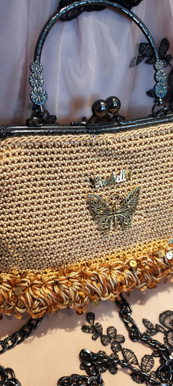 Side view of the Golden Glow Royal Bloom handbag with a detailed shot of the round handle and fringe base
