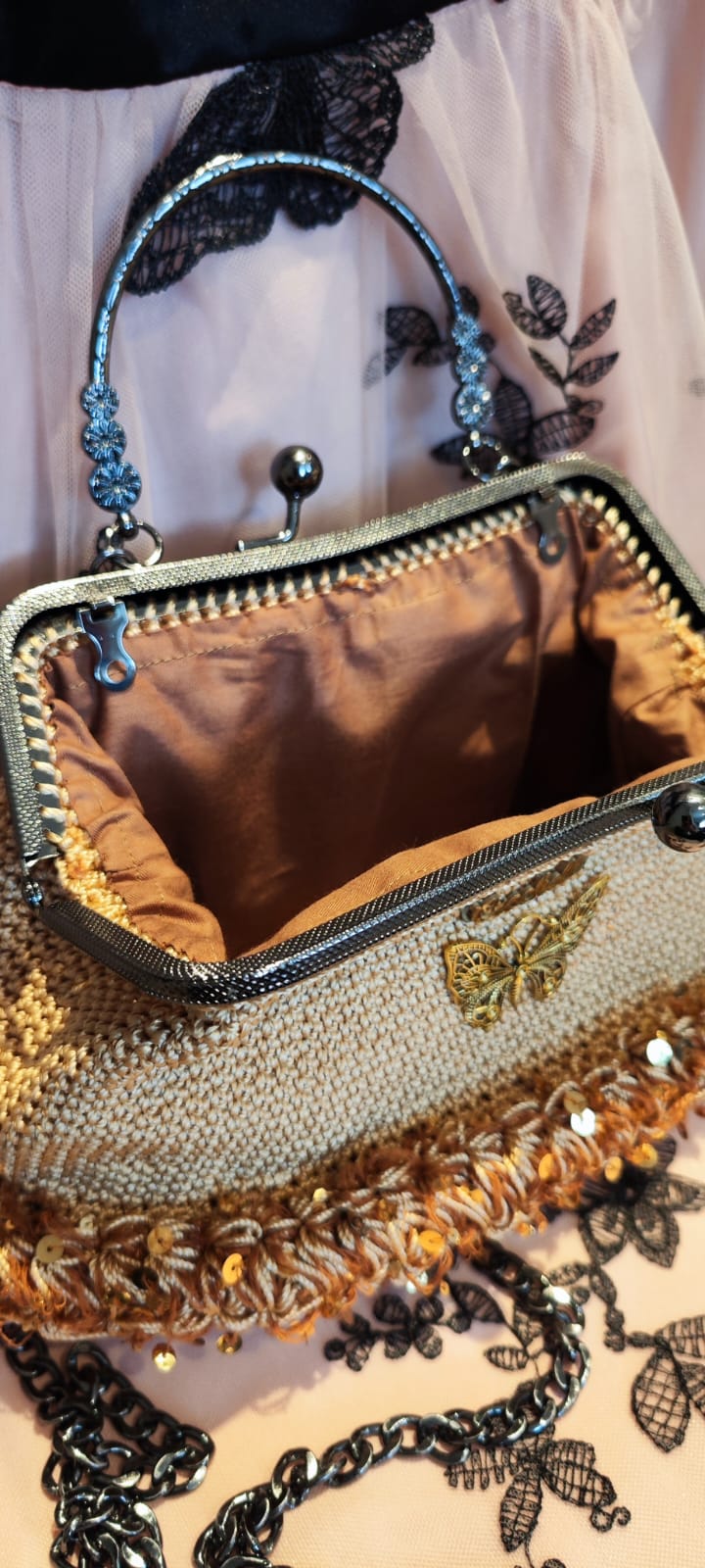 Close-up of the Golden Glow crochet texture and the Crochella logo on a butterfly-embroidered background.