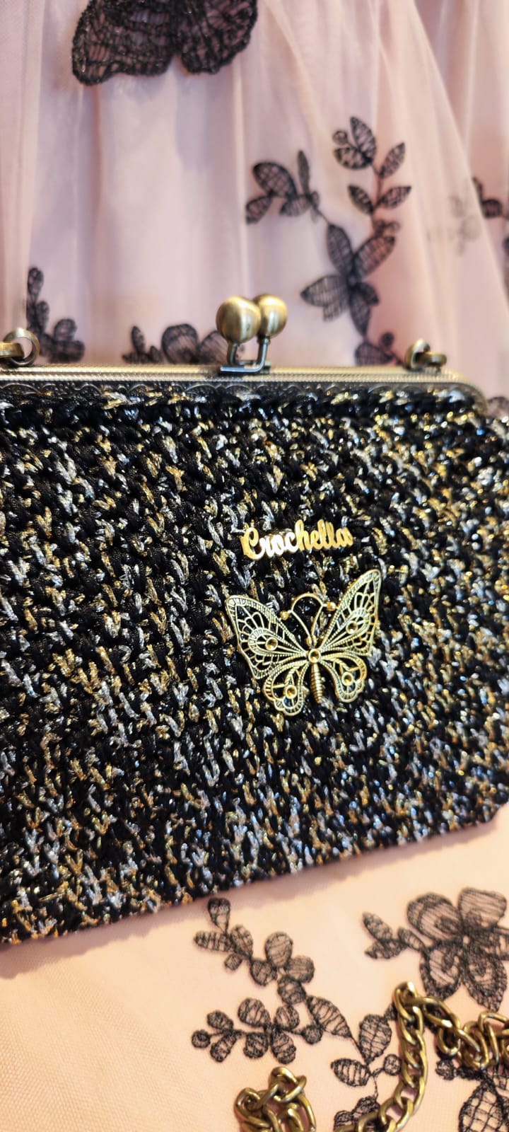 Angled view of the Midnight Bloom bag showing the sparkly yarn and antique metal clasp.