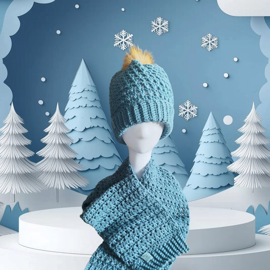 Sky Blue handmade crochet beanie and scarf set styled on a mannequin, with faux-fur pom-pom and cozy winter backdrop.
