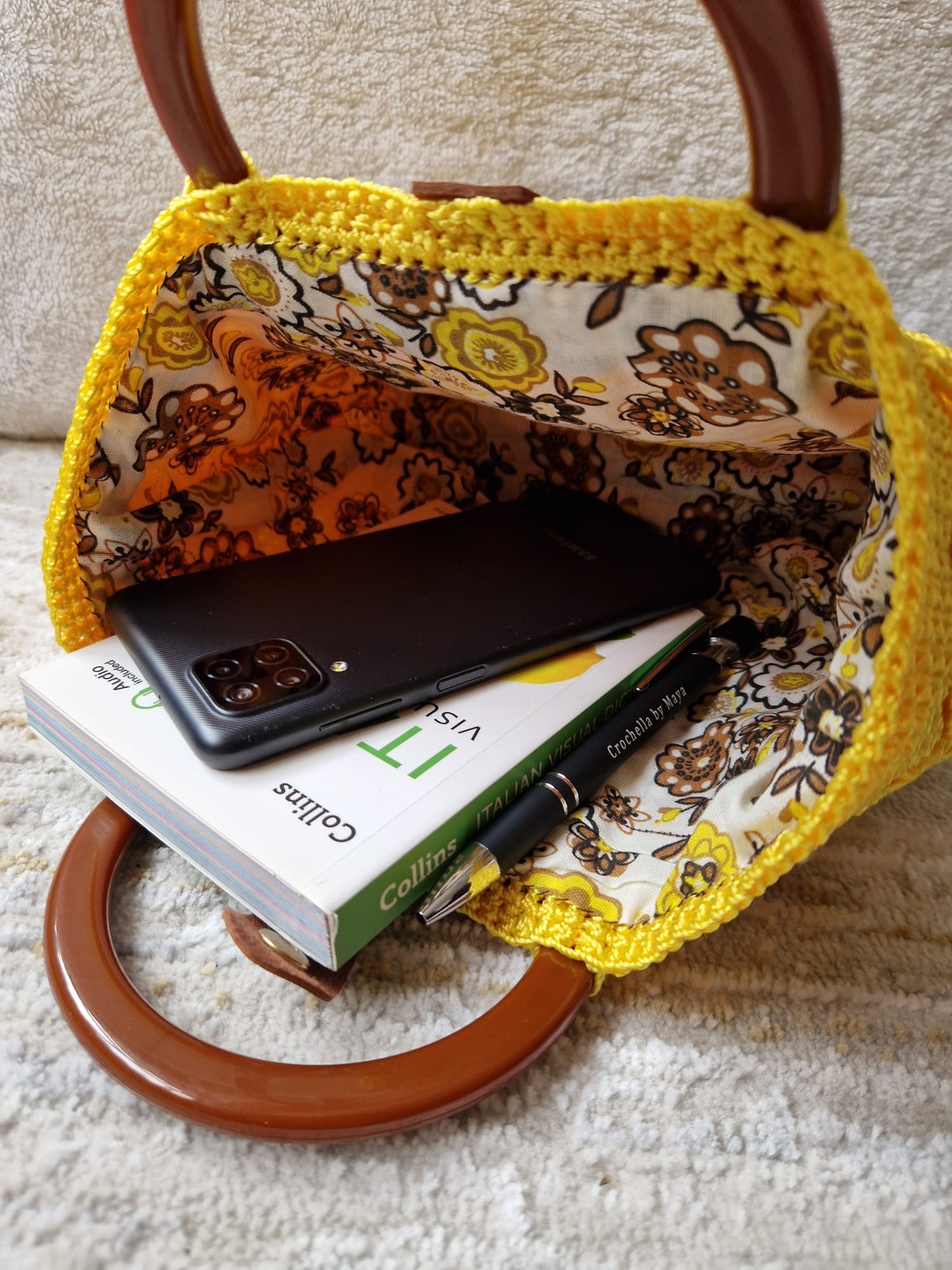 Angled view of the Sunburst Bloom Handbag showcasing its 3D textured crochet work and structured silhouette.