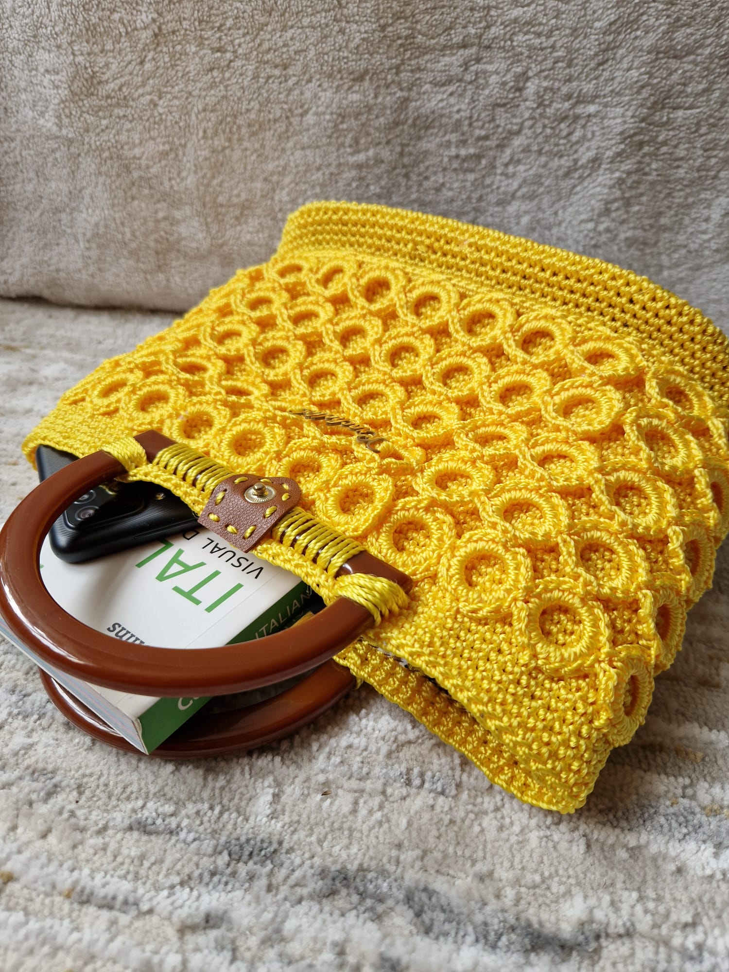 Close-up of the Sunburst Bloom Crochet Bag showing the intricate handmade circle motif and gold Crochella logo