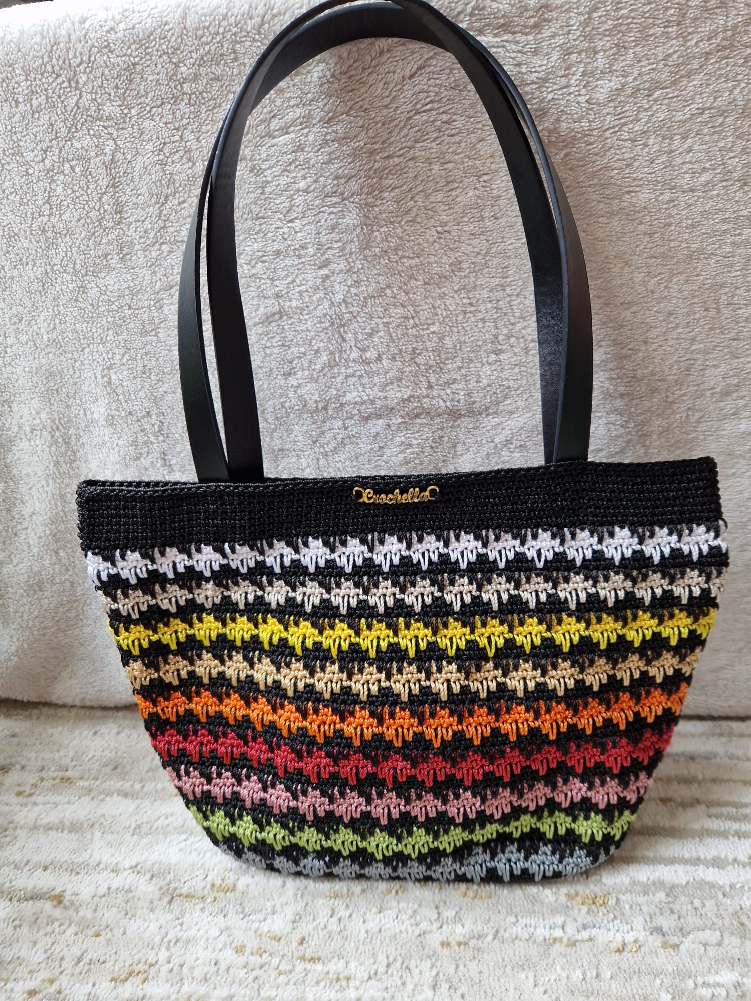 The Sunset Stripes Crochet Tote styled in a lifestyle setting, ideal for summer outings and vibrant everyday wear.