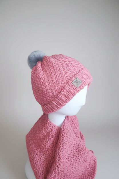  Flat lay of the Blush Rose crochet beanie and matching scarf showing cozy texture and handcrafted finish.