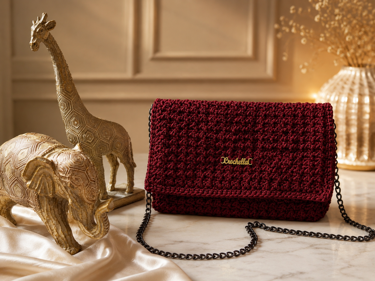 Red crochet clutch bag with crochella branding on a front of the bag
