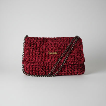 Front view of the Crimson Luxe handmade crochet clutch with elegant fold-over flap and black chain strap