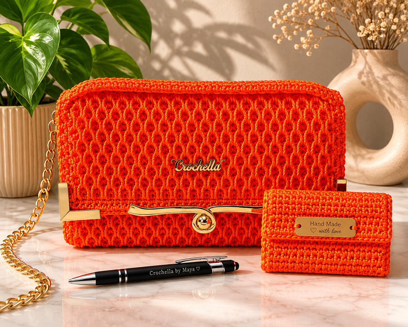 Orange textured handbag with gold chain and matching wallet on a light surface with decorative plants.