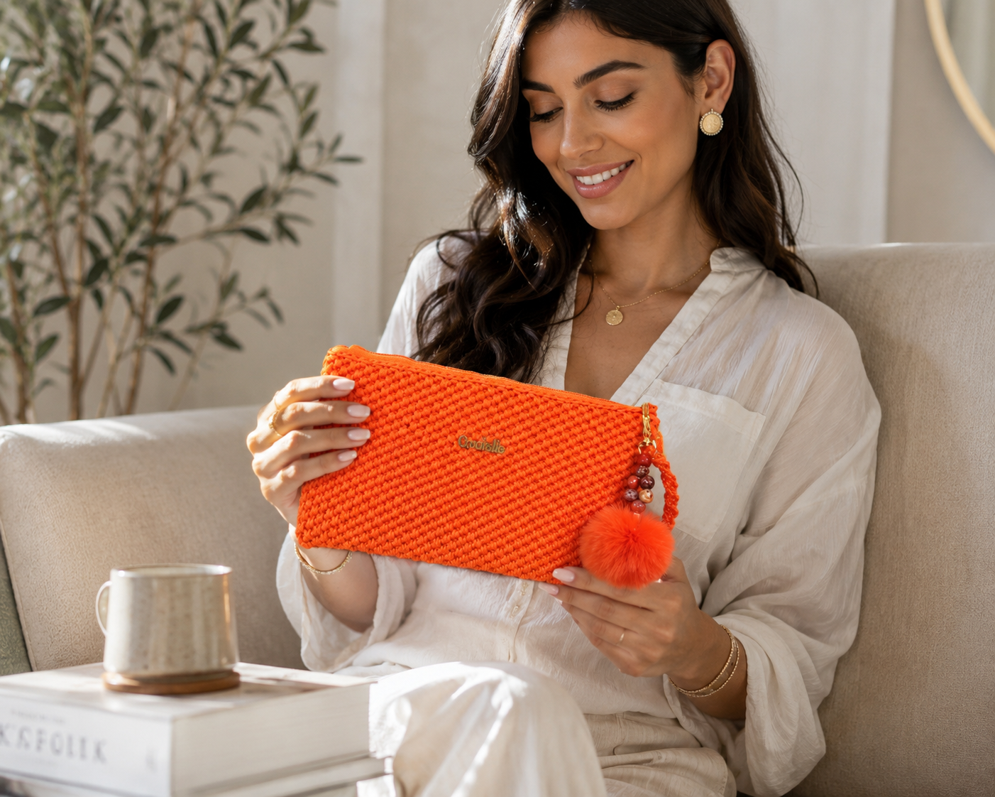Handmade orange crochet pouch with beaded charm and soft luxury styling