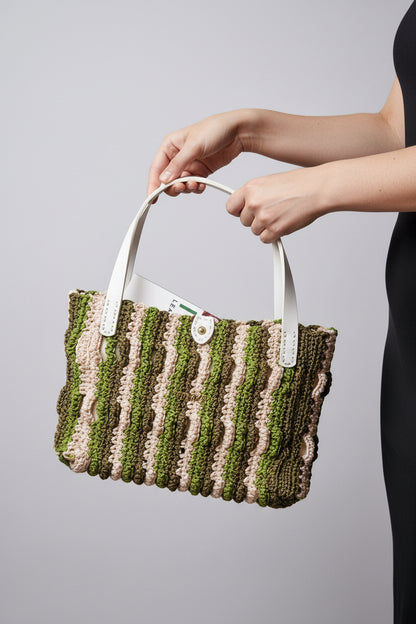 Close-up of the Forest Waves Crochet Bag showing wavy stitch pattern in green, beige, and olive with the Crochella logo.