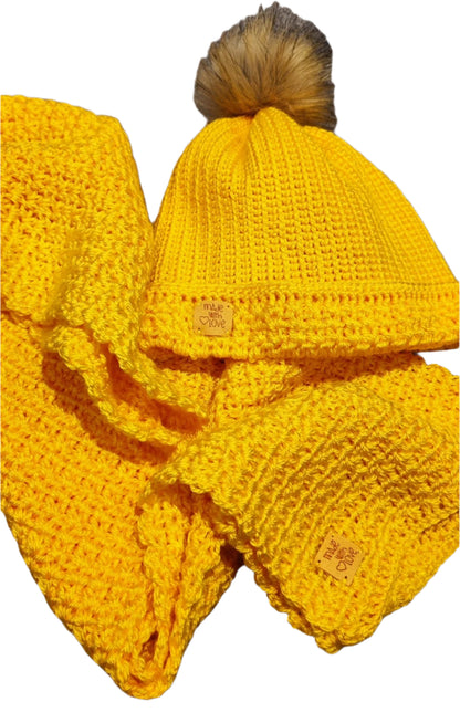  Flat lay of the Golden Sun crochet winter set showing the beanie with pom-pom and matching thick scarf.