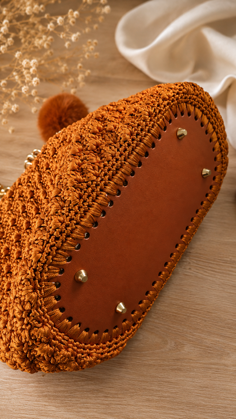 Structured base with protective metal feet on the MK Lunèra Crochella Amber Luxe Handbag