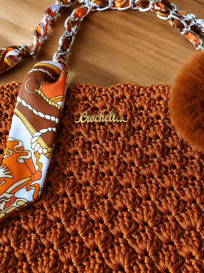 Luxury scarf-wrapped chain handle detail on the MK Lunèra Crochella Amber Luxe Handbag.