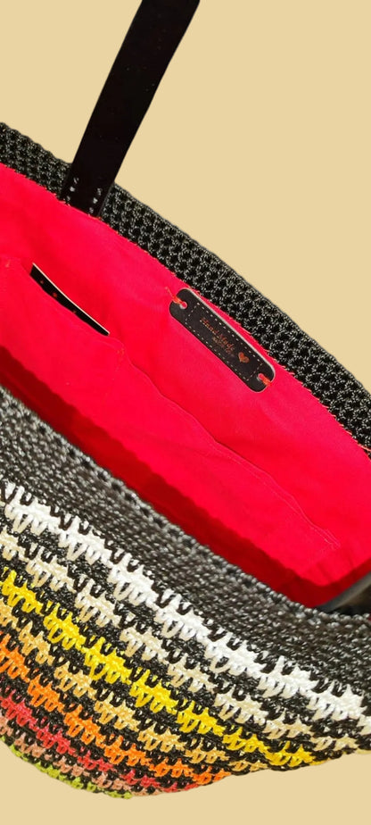 Close-up of the Sunset Stripes Tote’s rich gradient stitching and durable dark brown handles.